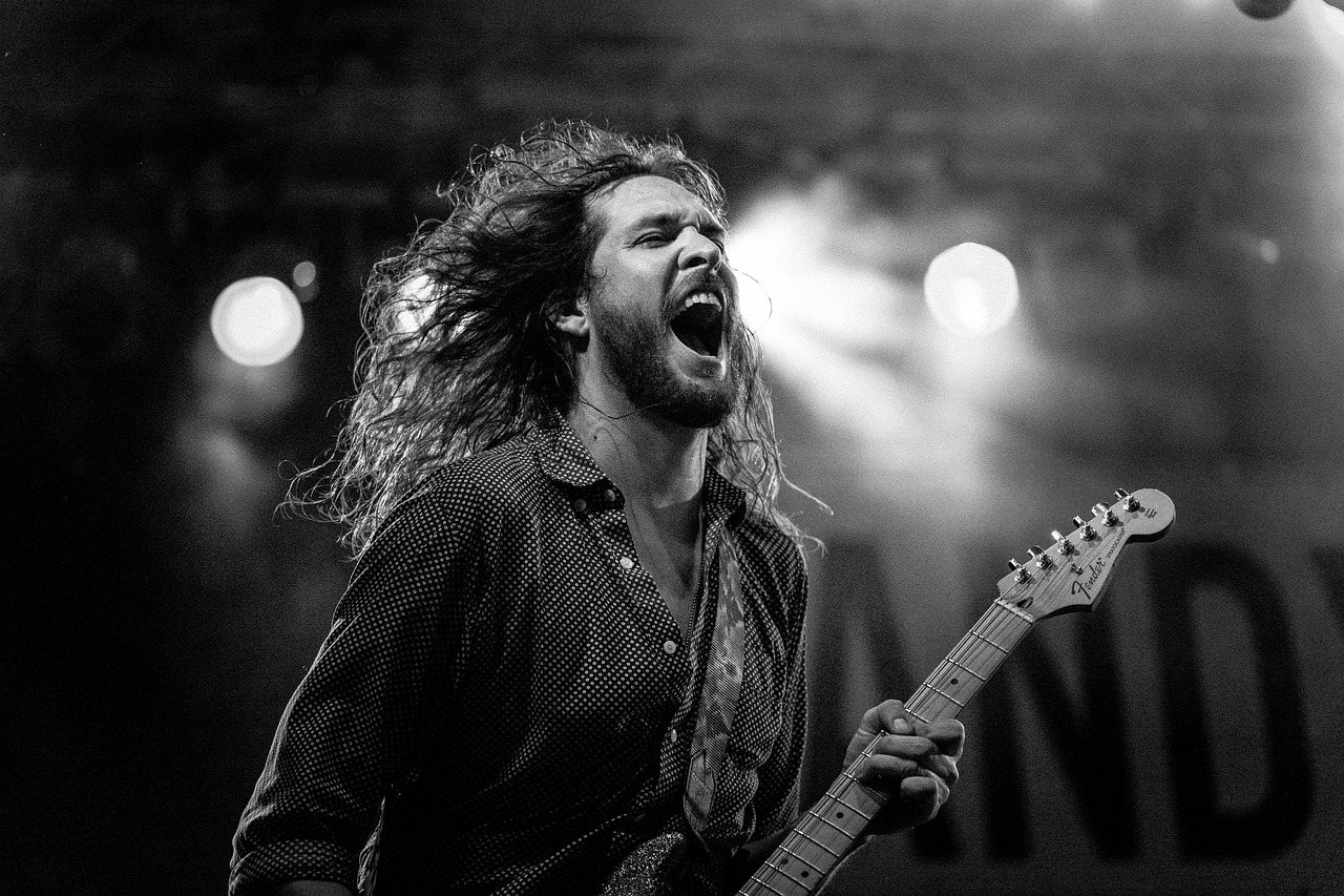 a man with long hair singing